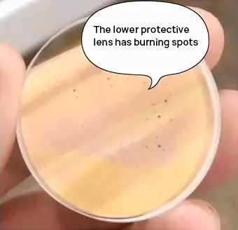 aparecen manchas negras en la lente protectora inferior de la cortadora láser