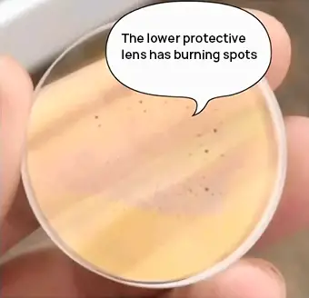 black spotsburn spots appear on the lower protective lens of the laser cutter